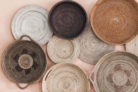 Wall decorated with different wicker handmade trays and baskets. Eco style and concept, Moroccan...