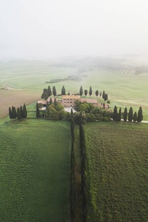San Quirico Dorcia, Italy - May 11, 2018: Aerial view of Borborini Maria Eva - one of the most famous places in Tuscany. Foggy spring morningのeditorial素材