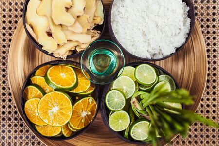 Natural organic ingredients for spa, bath and scrub: slices of fresh ginger, orange, lime, sea salt...