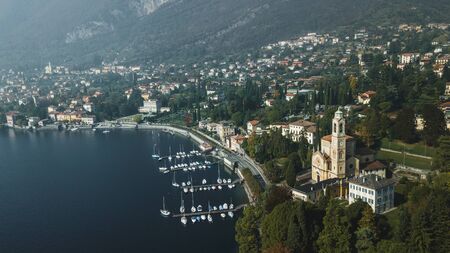 Aerial panoramic drone view of Lago di Como lake coastline, Italy. Foggy weather and mountains on...