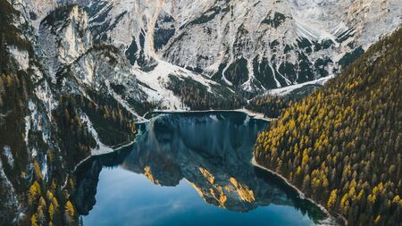 Amazing autumn landscape of Lago di Braies Lake in italian Dolomites mountains in north Italy . Drone aerial photo with beautiful reflection in calm water in the morning. Pragser Wildsee, South Tyrolの写真素材