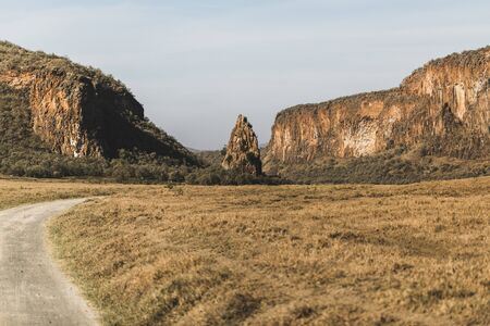 Safari in Hells Gate national park in Kenya. Basalt mountain and rock, main landmark. Explore wilderness of Africa.の写真素材