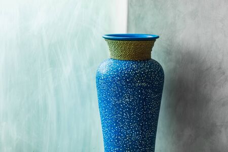 Blue vintage vase on gray concrete wall background. Minimalist modern interior designの写真素材