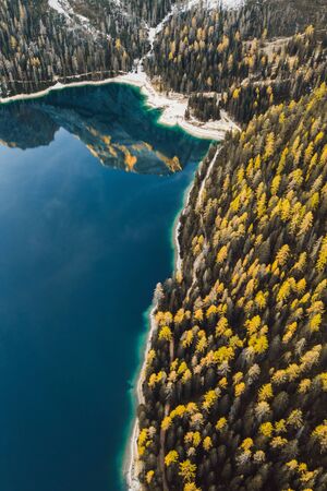 Amazing autumn landscape of Lago di Braies Lake in italian Dolomites mountains in north Italy . Drone aerial photo with beautiful reflection in calm water in the morning. Pragser Wildsee, South Tyrolの写真素材