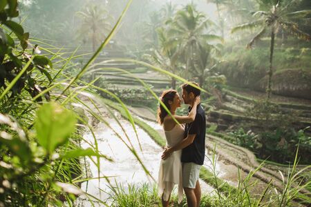 Young latin american couple with amazing view of Ubud rice terraces in morning. Happy together, honeymoon in Bali. Travel lifestyle.の写真素材