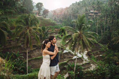 Young latin american couple with amazing view of Ubud rice terraces in morning. Happy together, honeymoon in Bali. Travel lifestyle.の写真素材