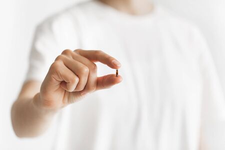 Person holding in fingers micro chip for implantation. Future mandatory chipization of people....