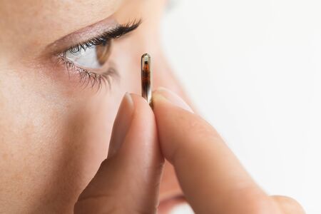 Chipization population concept. Medical implantation of microchip in eye close-up. Future and modern technology of health control of citizens.の写真素材