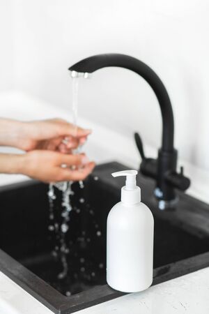 Prevention of coronavirus. Washing hands with soap and use antiseptic. Covid-19 pandemic. Bottle of antibacterial cleanser.の写真素材