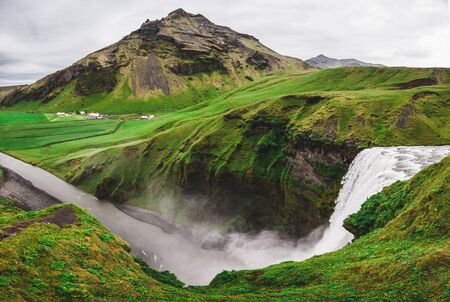 Green mountain view from top of Skogafoss Iceland famous waterfall. Iceland golden circle main landmark.の写真素材