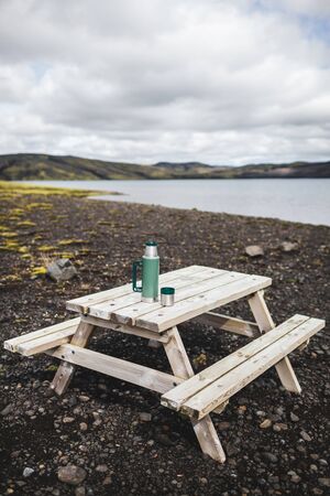 Simple wooden picnic table outdoors with lake view in Iceland Lakagigar.の写真素材