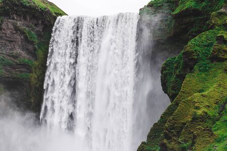 Skogafoss Iceland famous waterfall. Powerful stream, dramatic view with nobody. Icelandic golden ring main landmark.の写真素材