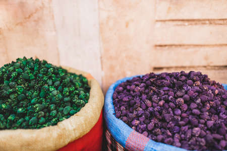 Colorful different dried natural fruit tea in blue and red bags on local market in Marrakesh medina.Textured arabian style background.の写真素材