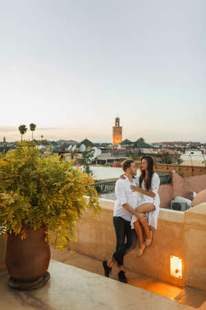 Romantic evening for couple in honeymoon. Rooftop terrace with view of Marrakesh in Morocco. Wedding in Africa.の写真素材