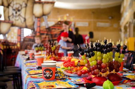 covered festive table in pirate symbolism with food on a pirate partyの写真素材