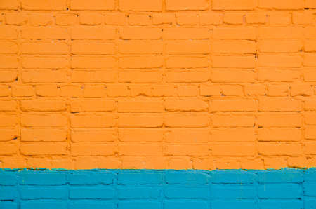 brick wall painted wit orange-blue color. saturated color.の写真素材