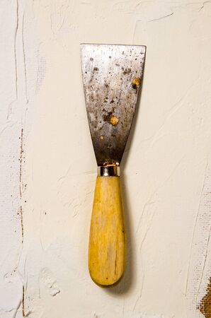 a vintage putty knife on the background of puttyの写真素材