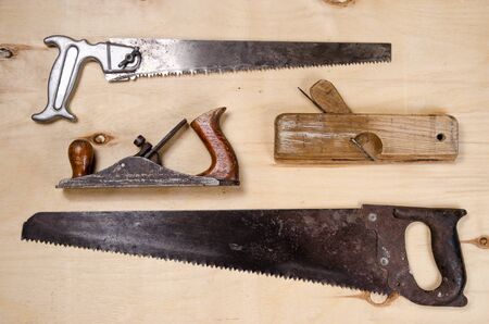 a set of tools for working on a timber - saw, plane, jointer - lay on a sheet of plywood. flat view.の写真素材