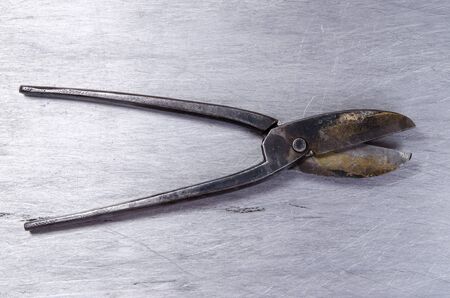 scissors for metal lay on a sheet of alluminium. vintage.の写真素材