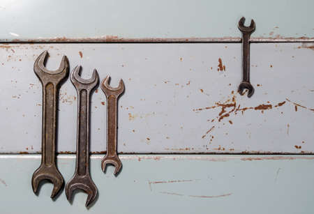 several wrenches on the background of metal painted platesの写真素材