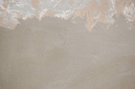 partly peeling painted wall covered with grey paint. place for textの写真素材