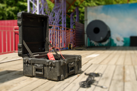 Plastic box with wires for connecting sound equipment on an open stage in the summerの写真素材