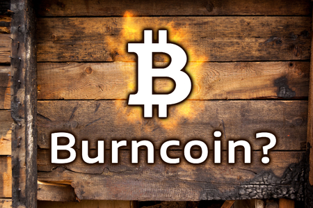 The symbol of bitcoin and the inscription "Burncoin?" against the backdrop of charred boards. The concept of unreliability and instability of bitcoins.の写真素材