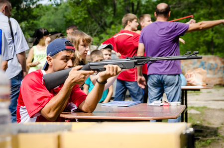 KOMSOMOLSK-ON-AMUR, RUSSIA, AUGUST 1, 2015. Public open Railroader's day. man shoot from pneumatic guns in amateur competitionのeditorial素材