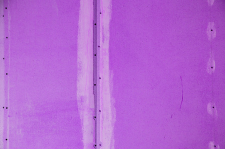 wall of hardboard with traces of glue and paint. tonedの写真素材