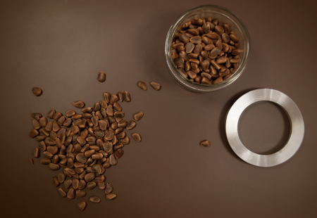 Crude pine nuts on brown background top view. Organic and healthy food.の写真素材