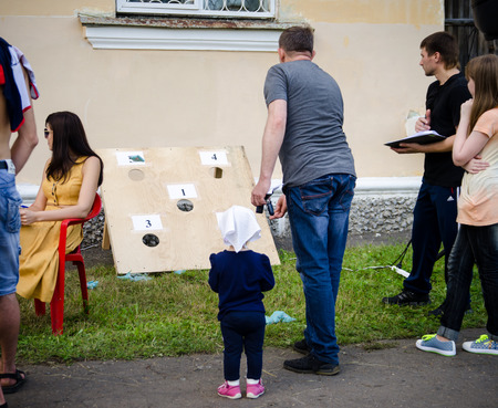 Komsomolsk-on-Amur, Russia - August 1, 2016. Public open Railroader's day. man throws sandbag at target in amateur competitionsのeditorial素材