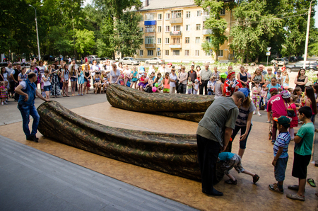 Komsomolsk-on-Amur, Russia - August 1, 2016. Public open Railroader's day. kids are playing who are faster through the long bagのeditorial素材