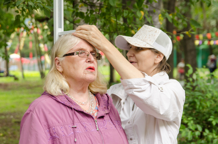Komsomolsk-on-Amur, Russia - August 19, 2018. female volunteer measures the growth of an elderly womanのeditorial素材