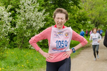 Komsomolsk-on-Amur, RUSSIA - JUNE 2, 2019. Running competitions among elderly sports veterans. female athlete finishes a distance in a running competition among senior athletesのeditorial素材