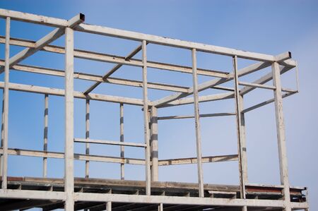 metal construction of a building under construction against the sky.