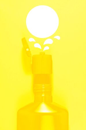 yellow open shampoo bottle and balloon for text over it on a light yellow background. vertical view.