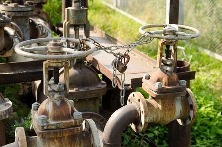 chain with a lock on the valves of water pipes. protection against unauthorized access.