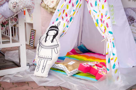 Komsomols-on-Amur, Russia - September 30, 2017. Wigham Native American Toy Tent for Kids in White Fabric with Color Patternのeditorial素材