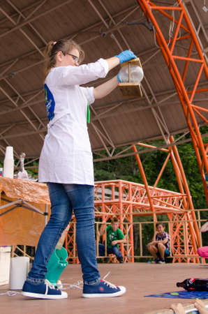 Komsomolsk-on-Amur, RUSSIA - AUGUST 27, 2018. Showing physical and chemical experiments for children. experience with nails and an inflated balloon. vertical view.のeditorial素材