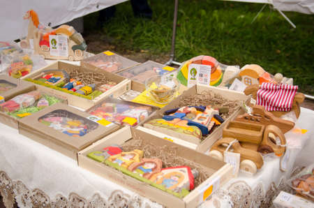 Komsomols-on-Amur, Russia - September 30, 2017. various hand-painted wooden eco-friendly handmade toys on sale at a city fairのeditorial素材