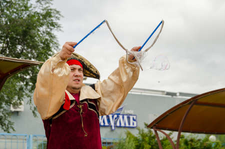 Komsomolsk-on-Amur, RUSSIA - JULY 21, 2018. An animator in a pirate costume tries to make soap bubbles.のeditorial素材