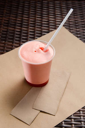 pink milkshake with juice in a transparent glass. vertical view.の写真素材