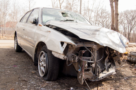 A crumpled hood and a broken windshield of a car that got into an accident.の写真素材