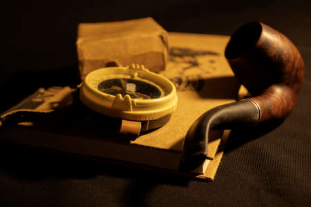 Retro compass on a book with a sailor's pipeの写真素材