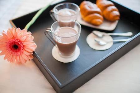 Breakfast tray in bed in hotel room.の写真素材
