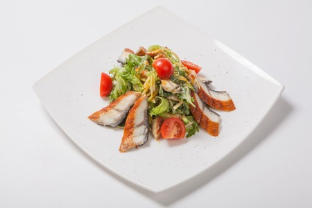 Salad with grilled fish with cherry tomatoes and Parmesan cheeseの写真素材