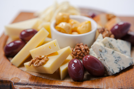 various assorted cheese on the wooden boardの写真素材