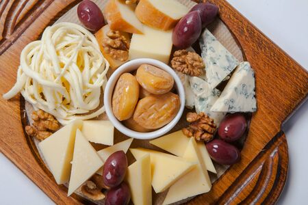 various assorted cheese on the wooden boardの写真素材