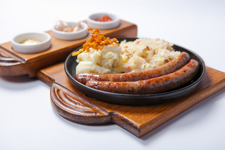 grilled sausages, and sauces and potatoes on cooking panの写真素材