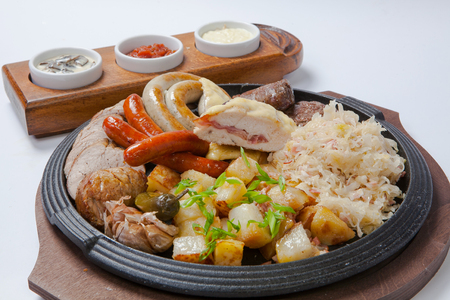 grilled sausages, and sauces and potatoes on cooking panの写真素材